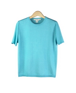 This short sleeve jewel neck sweater has a narrow rib-banded bottom, cuffs and a finely ribbed jewel neck. It is 100% silk, tightly knitted in fine 14 gauge smooth flat knit.  This style has a sporty look and an easy fit.  The crew neck sweater has a silky smooth feel that allows it to drape nicely; it is never clingy.  It is a favorite all-year-round sweater because of its classic style and comfort.  This sweater works beautifully with jackets, blazers, suits, trousers and jeans.  

Mid hip length.  Hand wash cold and lay flat to dry or dry clean. 

DISPLAY PICTURE COLOR: TURQUOISE